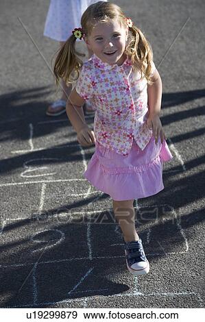 Stock Photo - Young girls playing hopscotch. Fotosearch