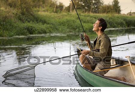 Stock Photo - Young man fishing. Fotosearch