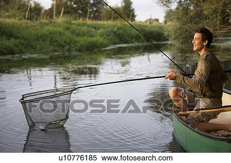 Young man fishing View Large Photo Image Stock Photography - Young man fishing. Fotosearch