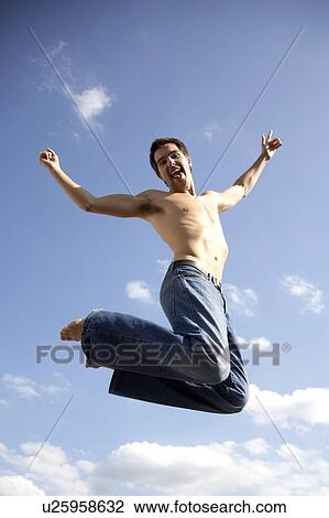 Young man jumping View Large Photo Image Stock Image - Young man jumping. Fotosearch