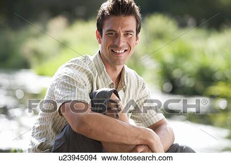 Young man sitting in the sun View Large Photo Image Picture - Young man sitting in the sun. Fotosearch
