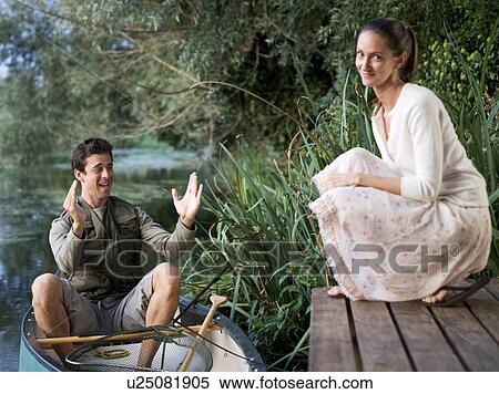 Young man telling tales of the fish that got away View Large Photo Image Stock Photography - Young man telling tales of the fish that got away. Fotosearch