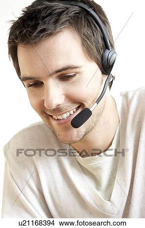 Young man wearing a headset View Large Photo Image Picture - Young man wearing a headset. Fotosearch