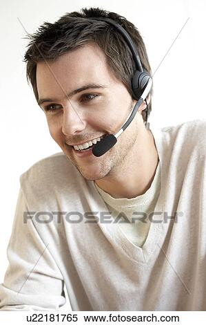 Stock Photography - Young man wearing a headset. Fotosearch