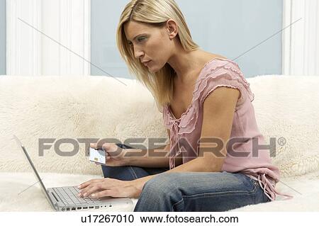 Young woman shopping on the internet View Large Photo Image Stock Image - Young woman shopping on the internet. Fotosearch