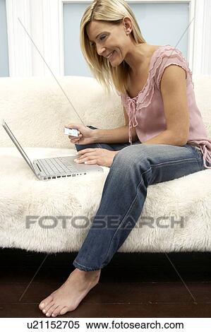 Stock Photography - Young woman shopping on the internet. Fotosearch