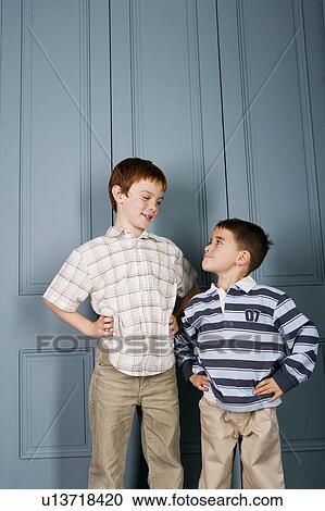 Younger boy staring up at older boy View Large Photo Image Stock Image - Younger boy staring up at older boy. Fotosearch