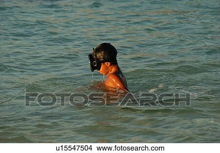 A young boy wearing scuba goggles in water View Large Photo Image Picture - A young boy wearing scuba goggles in water. Fotosearch