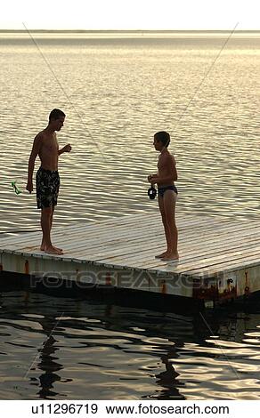 A young couple standing on a raft View Large Photo Image Stock Photo - A young couple standing on a raft. Fotosearch
