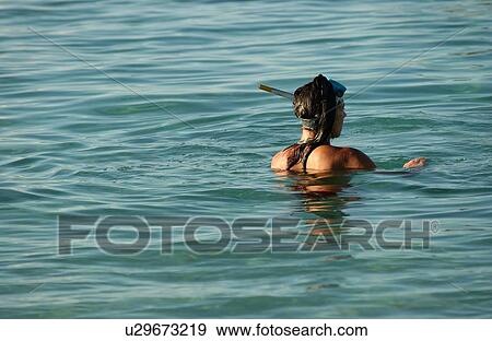 A young man wading in water, Moorea, Tahiti, French Polynesia, South Pacific View Large Photo Image Stock Photo - A young man wading in water, Moorea, Tahiti, French Polynesia, South Pacific. Fotosearch