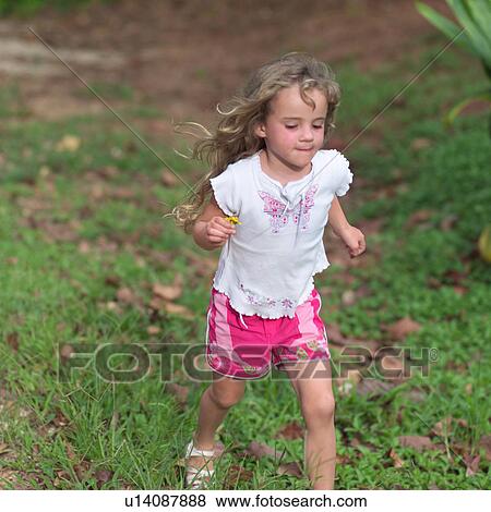 Stock Photo - Blond Child in Shorts Running. Fotosearch