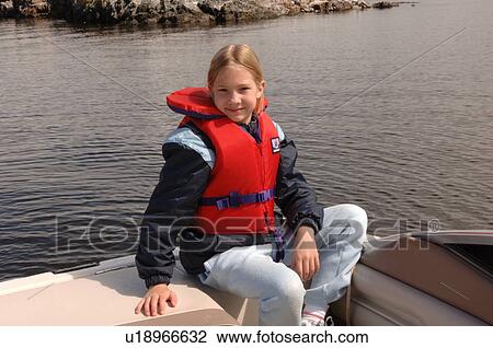 Stock Image - Blond girl wearing a lifejacket. Fotosearch