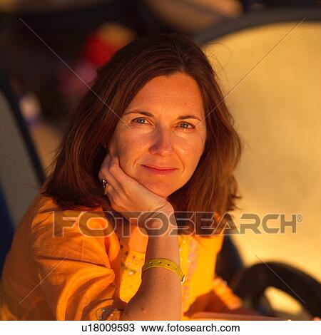 Stock Image - Brunette woman looking at the camera. Fotosearch