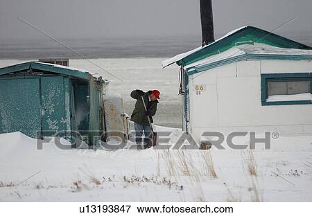 Churchill Northern Manitoba town and surroundings Man shovelling snow View Large Photo Image Stock Photo - Churchill Northern Manitoba town and surroundings Man shovelling snow. Fotosearch