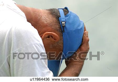 Close-up of a mid adult man holding his head in his hands, Papeete, Tahiti View Large Photo Image Stock Photograph - Close-up of a mid adult man holding his head in his hands, Papeete, Tahiti. Fotosearch