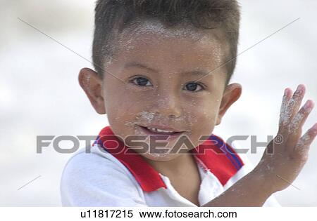 Stock Photography - Close-up of a young boy on the beach. Fotosearch