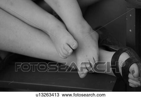 Close-up of the legs of a young girl on a the leg of a woman View Large Photo Image Stock Image - Close-up of the legs of a young girl on a the leg of a woman. Fotosearch