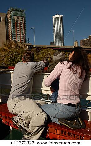 Stock Photo - Couple sitting with a child. Fotosearch