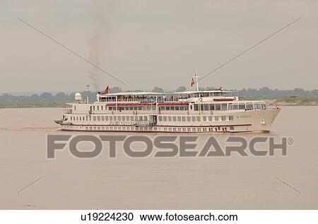 Stock Image - Cruise boat on the Irrawaddy River. Fotosearch