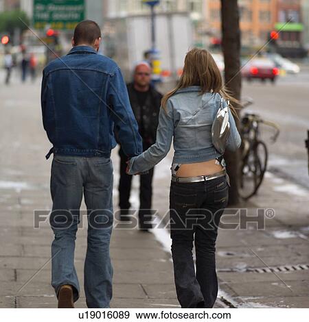 Stock Photo - Dublin, Ireland - Man and Woman holding hands. Fotosearch