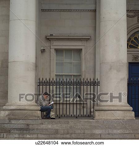 Dublin, Ireland - man sitting reading in front of Custom House View Large Photo Image Picture - Dublin, Ireland - man sitting reading in front of Custom House. Fotosearch