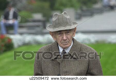 Stock Image - Elderly man walking in a park in Prague. Fotosearch