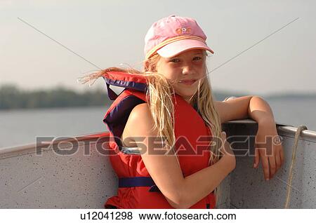Stock Photo - Eleven year old girl in a boat. Fotosearch