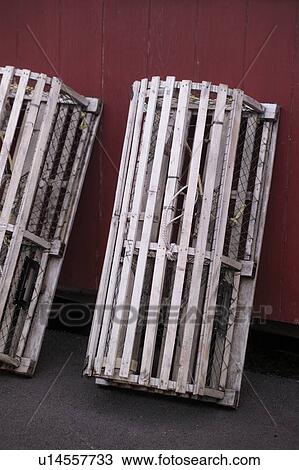 Stock Image - Lobster traps leaning against a wall. Fotosearch