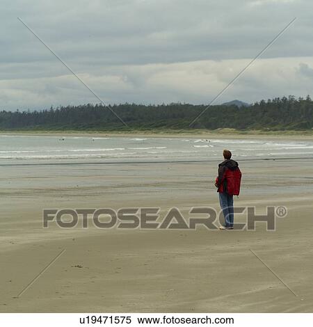 Man standing on beach View Large Photo Image Stock Photography - Man standing on beach. Fotosearch