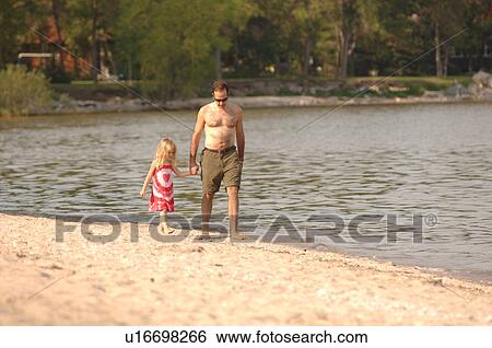 Matlock, Manitoba, Father and daughter walking along beach View Large Photo Image Stock Photograph - Matlock, Manitoba, Father and daughter walking along beach. Fotosearch
