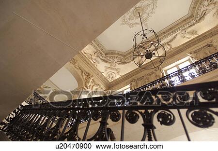 Stock Image - Metal railing of a staircase in a building in Paris, France. Fotosearch