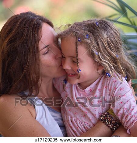 Mother cuddling with her daugher View Large Photo Image Stock Photography - Mother cuddling with her daugher. Fotosearch