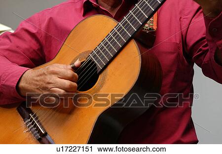 Stock Image - Person playing a guitar, Havana, Cuba. Fotosearch