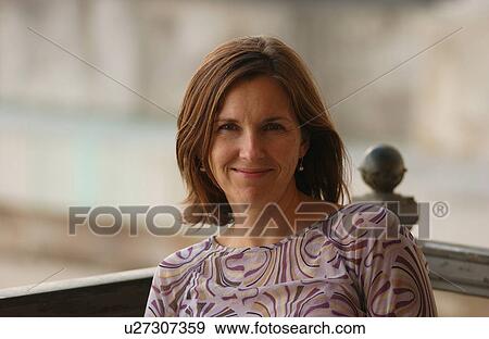 Stock Photo - Portrait of a woman sitting outdoors, Havana, Cuba. Fotosearch