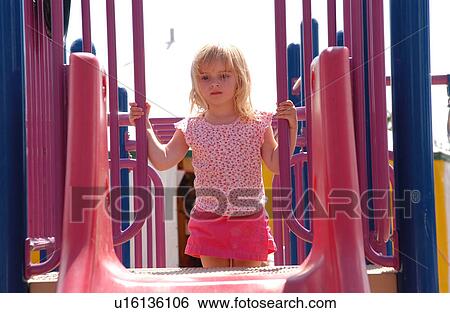 Portrait of a young girl climbing a slide View Large Photo Image Stock Photograph - Portrait of a young girl climbing a slide. Fotosearch