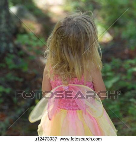 Rear view of a young girl in a fairy costume View Large Photo Image Stock Photo - Rear view of a young girl in a fairy costume. Fotosearch
