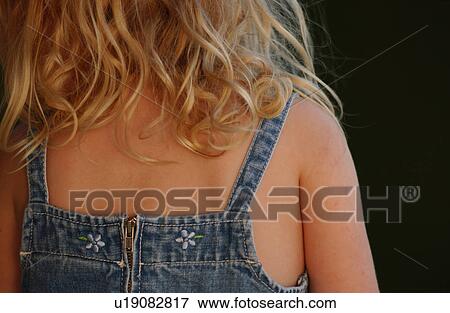 Rear view of a young girl sitting View Large Photo Image Stock Photo - Rear view of a young girl sitting. Fotosearch