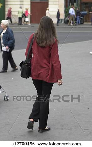 Rear view of a young woman walking in Paris, France View Large Photo Image Stock Photograph - Rear view of a young woman walking in Paris, France. Fotosearch
