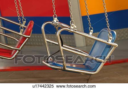 Seats of a merry go round in an amusement park at Navy Pier in Chicago View Large Photo Image Stock Photography - Seats of a merry go round in an amusement park at Navy Pier in Chicago. Fotosearch