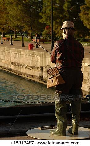 Statue of a man fishing at an amusement park at Navy Pier View Large Photo Image Stock Photo - Statue of a man fishing at an amusement park at Navy Pier. Fotosearch