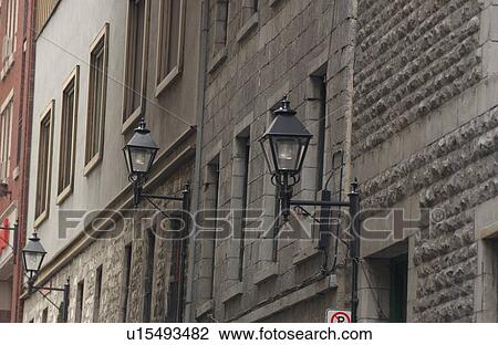 Stock Image - Street lights on the side of buildings in Montreal, Canada. Fotosearch