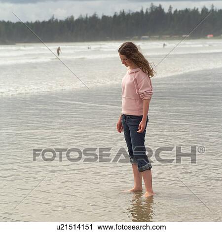 Teenage girl standing on beach View Large Photo Image Stock Image - Teenage girl standing on beach. Fotosearch