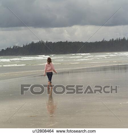 Teenage girl walking on beach, Pacific Rim Park, Vancouver Island, Canada View Large Photo Image Picture - Teenage girl walking on beach, Pacific Rim Park, Vancouver Island, Canada. Fotosearch