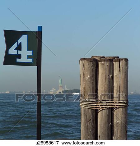 View of Statue of Liberty from Admiral Dewey Promenade, Battery Park, New York City View Large Photo Image Stock Photo - View of Statue of Liberty from Admiral Dewey Promenade, Battery Park, New York City. Fotosearch