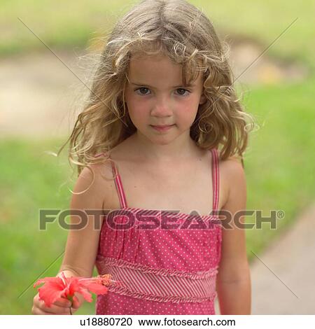 Young girl holding flower at Moorea in Tahiti View Large Photo Image Stock Image - Young girl holding flower at Moorea in Tahiti. Fotosearch