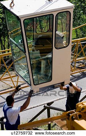 aerial view of crane cabin being lifted by two workmen, as crane is assembled View Large Photo Image Stock Image - aerial view of crane cabin being lifted by two workmen, as crane is assembled . Fotosearch
