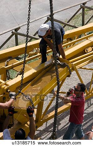 aerial view of men assembling crane boom with chains for lifting from ground View Large Photo Image Stock Photography - aerial view of men assembling crane boom with chains for lifting from ground . Fotosearch