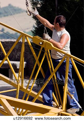 aerial view of workman assembling crane boom to be lifted from ground, catching swinging chain View Large Photo Image Stock Image - aerial view of workman assembling crane boom to be lifted from ground, catching swinging chain . Fotosearch