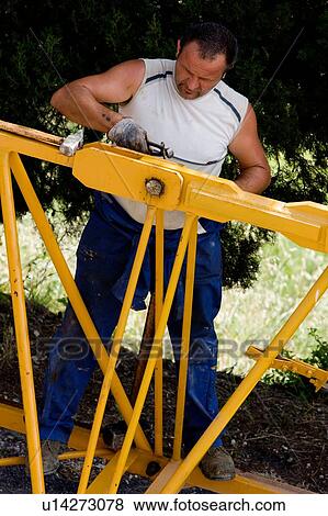 aerial view of workman assembling crane boom to be lifted from ground, using pliers View Large Photo Image Stock Photo - aerial view of workman assembling crane boom to be lifted from ground, using pliers . Fotosearch