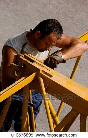 aerial view of workman assembling crane boom to be lifted from ground View Large Photo Image Stock Photography - aerial view of workman assembling crane boom to be lifted from ground . Fotosearch